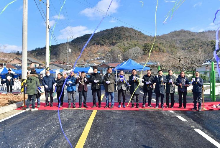장성읍 잠암마을 주민들이 24일 도로 확포장 공사 준공식을 갖고 자축하고 있다.
